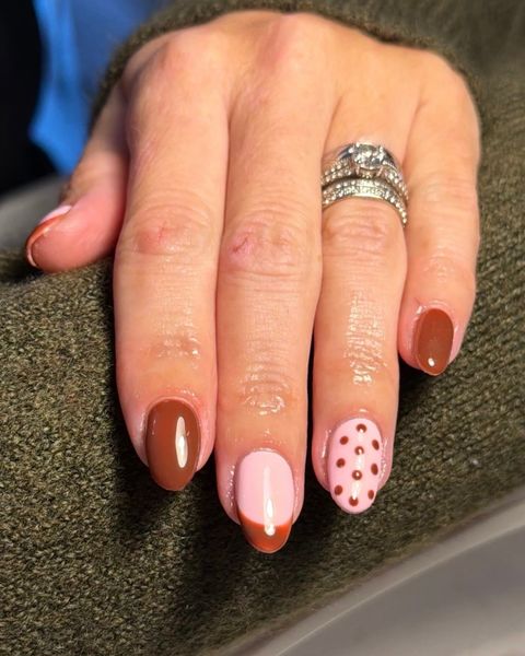 Gel nails in chocolate brown and baby pink with a polka dot accent nail